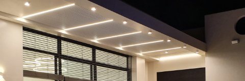 Lit pergola ceiling with LED strip lights and downlights above a terrace at night